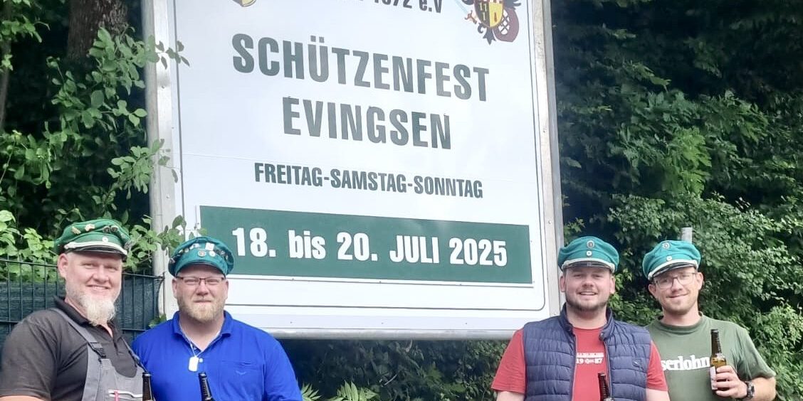 Evingser Schützen vor dem Ankündigungsschild.