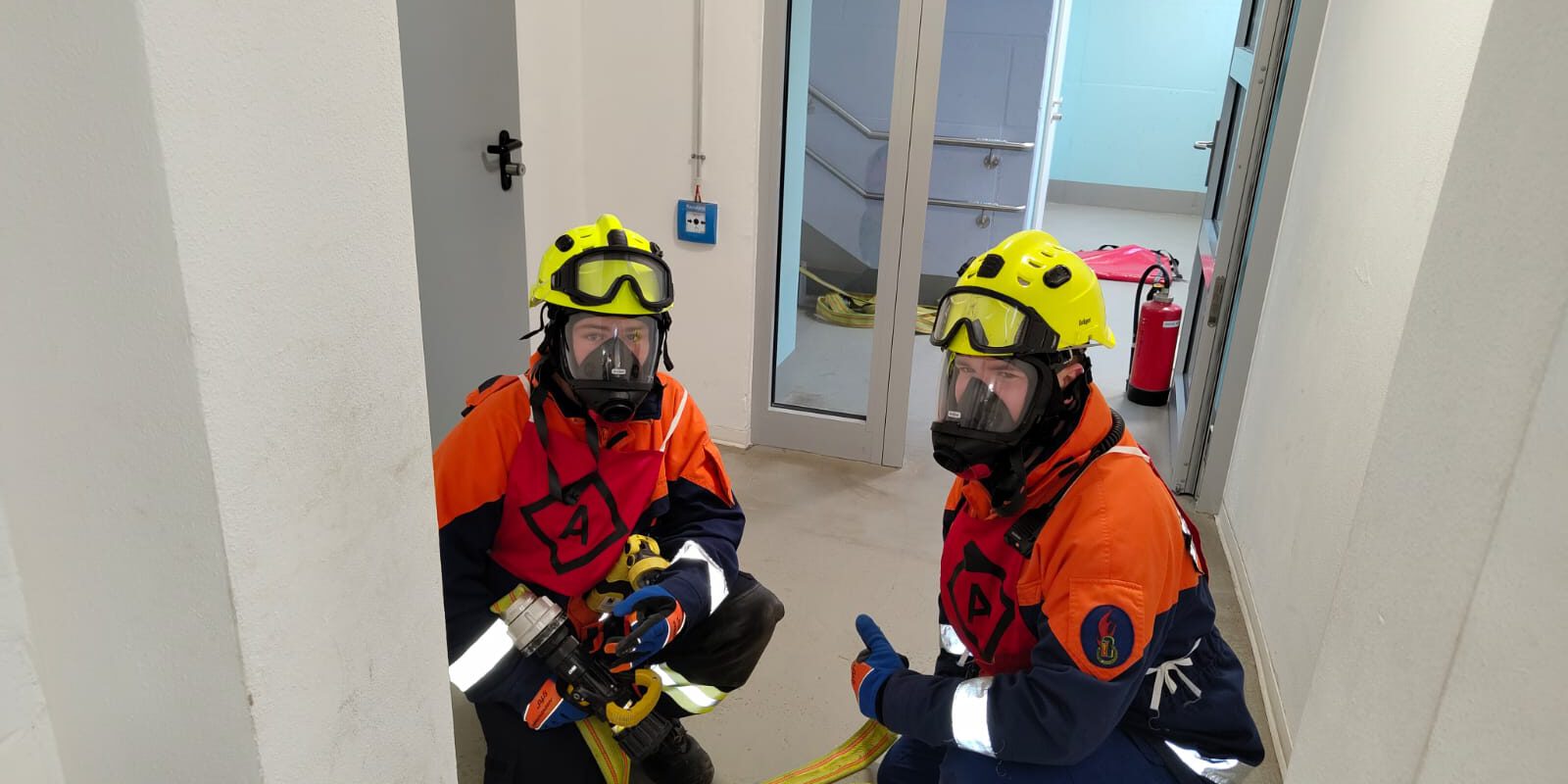 Zwei Kinder in Feuerwehrkleidung