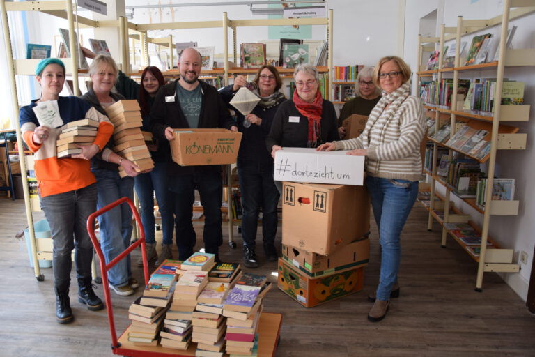 Das Team der Stadtbücherei Menden zwischen Umzugskartons und Bücherstapeln.